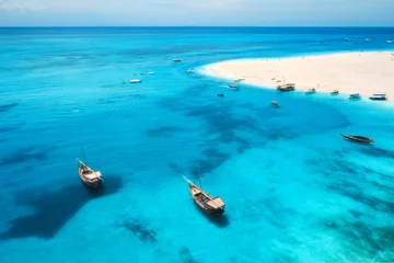 Foto op Plexiglas Aerial view of fishing boats on tropical sea coast with transparent blue water and sandy beach at sunny day. Summer holiday. Indian Ocean in Zanzibar, Africa. Landscape with boat, white sand. Top view © den-belitsky