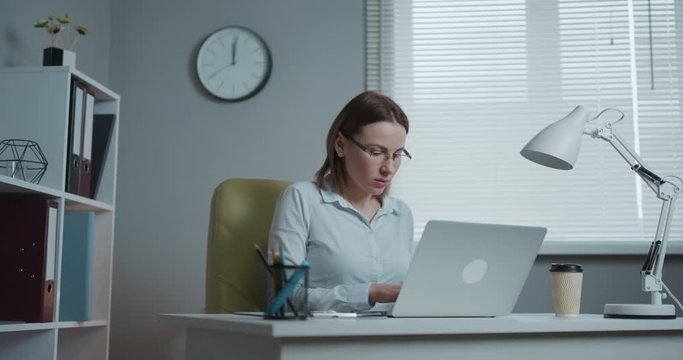 Businesswoman Working on a Laptop in Her Office. Strong Independend Female CEO Runs Business Company