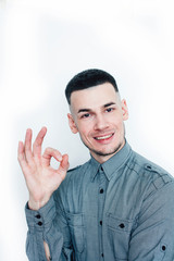 young handsome well groomed guy posing on white background gesturing smiling, lifestyle people concept