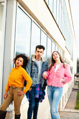 Obraz premium cute group of teenages at the building of university with books huggings, diversity nations real students lifestyle