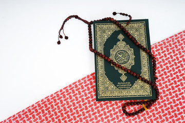 Quran and shemagh fabric - holy book of Muslims - Koran - quran on white background