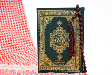 Quran and shemagh fabric - holy book of Muslims - Koran - quran on white background
