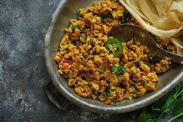 Scrambled eggs/ Masala egg Bhurji served with roti, selective focus