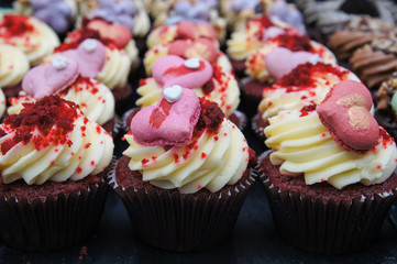 homemade cupcakes decorated with pink hearts