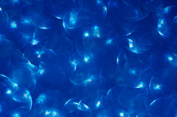 Abstract blue background with highlights and bokeh of the original shape. Out of focus.Trendy color.