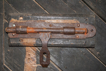 Richmond, Tasmania, Australia - December 13, 2009: Closeup of heavy rusty metal sliding door lock at historic gaol building.