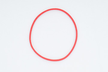 Red elastic bands on a white background