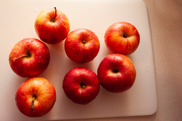 beautiful red apples on a cutitng board
