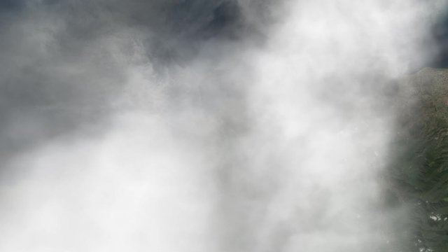 Large smoke clouds from volcano eruption, aerial satellite animation view of Sangean Api island in Indonesia. Contains public domain image by Nasa