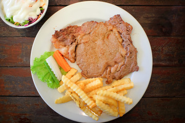 Beef steak placed on a wooden table