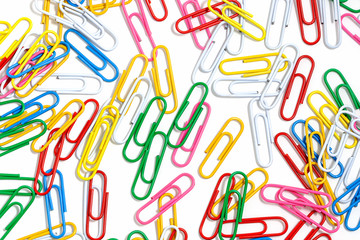 Fototapeta na wymiar Many multicolored paper clips on a white background.