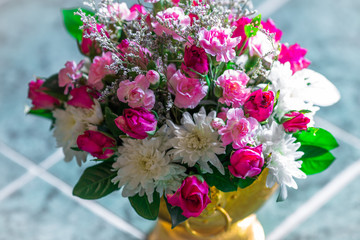 Close-up view of various flowers and roses arranged in vases for use in ceremonies (weddings, valentines, new years, visiting patients), light blurring, beauty Spectator