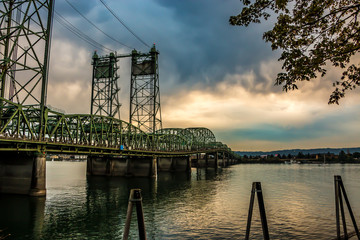 Colorful Sunset Over Columbia River Oregon Washington Bridge Dense Clouds stock photo