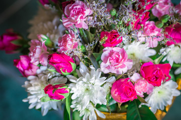 Close-up view of various flowers and roses arranged in vases for use in ceremonies (weddings, valentines, new years, visiting patients), light blurring, beauty Spectator