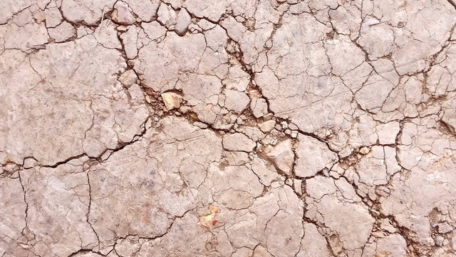 Images of damaged soil or closeup cracked land. Photo of  ground  texture background from top view.  Royalty free stock picture.