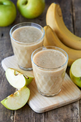 Two glasses of smoothie with banana and green apple