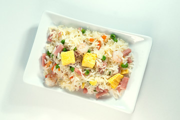 Three delicacies rice, on white rectangular plate with white background from top view