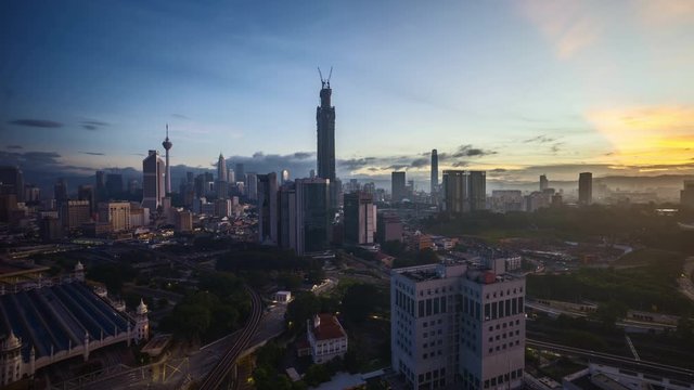4k time lapse of sunrise at Kuala Lumpur city horizon, aerial view. Zoom out