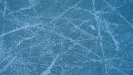 ice background with marks from skating and hockey, blue texture