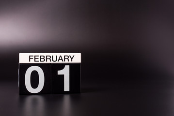 February 1st. Day 1 of february month, calendar on black background. Winter time. Leap-year