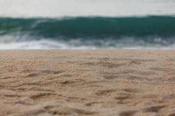 Close up of sand with waves on the background 