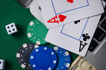Online casino, poker. Background for business online games, poker, blackjack game. Online card games. Laptop, money and chips.