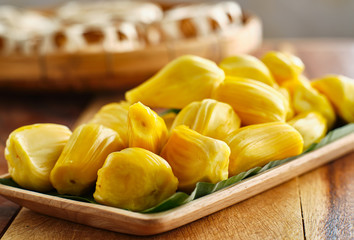 pile of peeled jackfruit on banana leaf serving tray,