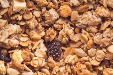 Useful and tasty muesli with nuts, rasins and flakes. Selective focus macro shot with very shallow depth of field. Healthy and vegetarian lifestyle