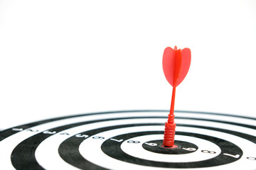 Wooden dartboard with red arrow on white background