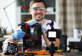 Male adult vloger make online broadcast portrait. Tells subscribers how to repair motherboards and...