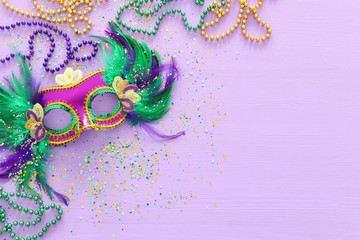 Holidays image of mardi gras masquarade venetian mask over purple background. view from above © tomertu