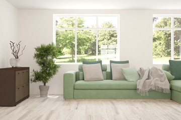 Stylish room in white color with sofa and summer landscape in window. Scandinavian interior design. 3D illustration