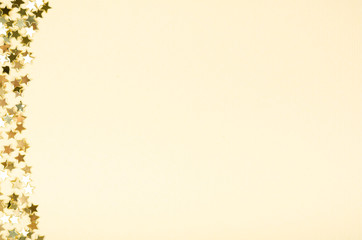 Golden stars composition on beige background, party and celebration decoration.