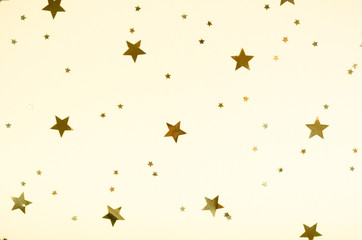 Golden stars composition on beige background, party and celebration decoration.