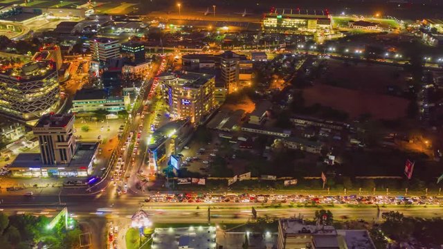 Aerial night timelapse of airport city with moving cars in Ghana