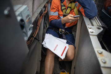 Building maintenance worker is using cellphone calling site emergency services when Building...