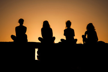 silhouettes of girls at sunset