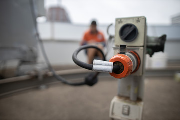 Defocused of building maintenance unit electrician inspecting holding paperwork clear powerpoint...