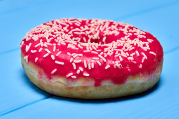 pink glazed donut on a blue background