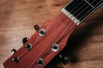 element of a beautiful new clean guitar, six-stringed musical instrument mahogany guitar, metal...