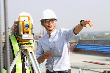 Engineers and staff are inspecting the buildings using theodolite..