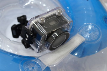 Action camera in waterproof box on a children's inflatable swimming circle, video shooting on the water, in the pool and underwater video