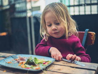 Toddler having lunch in a cafe