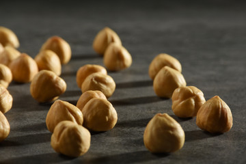 Hazelnuts on the black stone texture