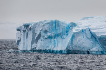 Fototapeta na wymiar Large iceberg floating in the cold water of Antarctica