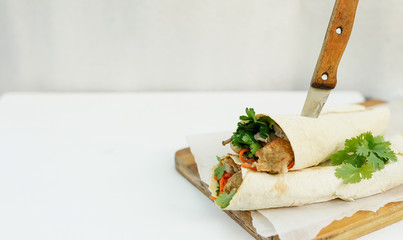 Doner kebab - fried chicken meat with vegetables in pita bread