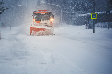 Snow plow truck clearing road after winter snowstorm blizzard for car..... © Zedspider
