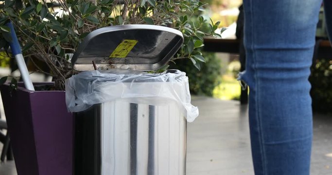 People are throwing garbage into the trash.Stainless steel trash in the cafe,Cleanliness, plastic waste