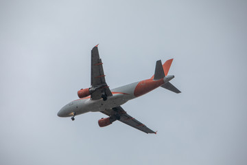 plane in sky landing overcast weather