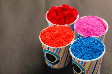 Indian festival holi, colors cup on wooden board